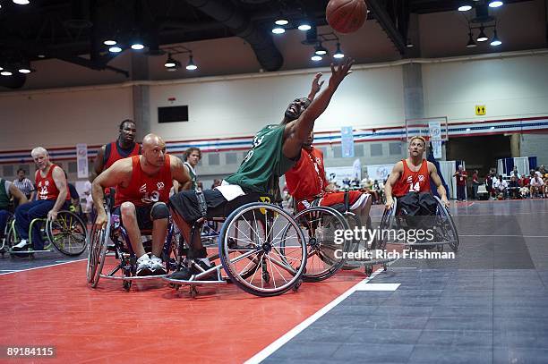 Wheelchair Basketball: 28th National Veterans Wheelchair Games: Green Team's Charles Allen in action, rebound vs Red Team's Jeff Deleon and Harold...