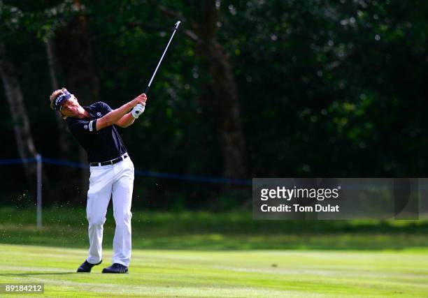 Bernard Langer takes a shot on 16th fairway during previews of the Senior Open Championship at the Sunningdale Golf Club on July 22, 2009 in...