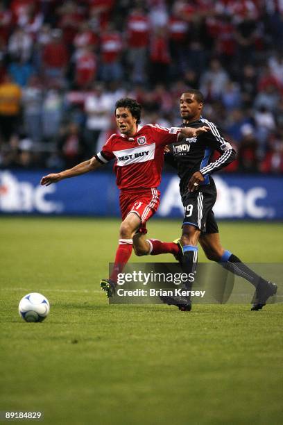 John Thorrington of the Chicago Fire moves the ball up the field as Ryan Johnson of the San Jose Earthquakes defends during the first half at Toyota...