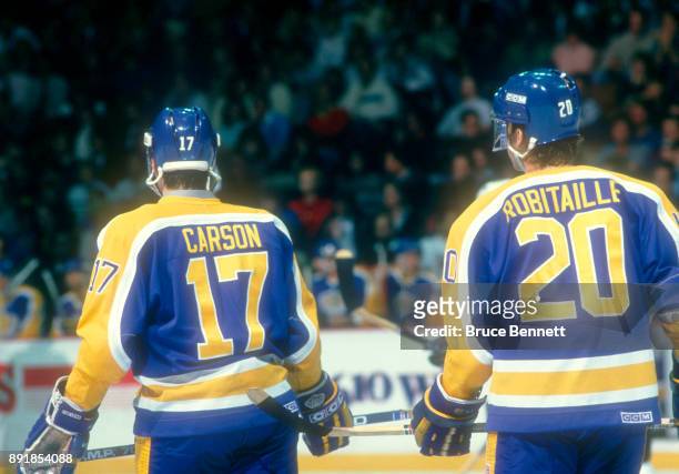 Jimmy Carson and Luc Robitaille of the Los Angeles Kings skate on the ice during an NHL game against the Philadelphia Flyers circa 1988 at the...