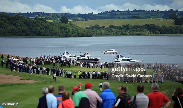 Huge crowds watch the players Padraig Harrington of Ireland and Rory McIlroy of Northern Ireland on the 7th hole during the Lough Erne Challenge, on...