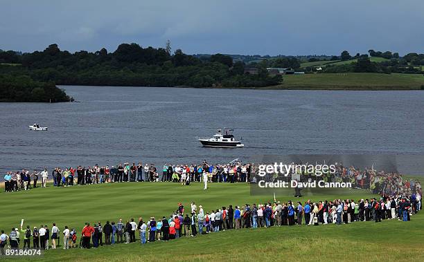 Rory McIlroy of Northern Ireland hits his second shot at the 8th hole watched by Padraig Harrington of Ireland during the Lough Erne Challenge, on...