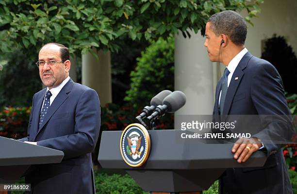 President Barack Obama looks on as Iraqi Prime Minister Nuri al-Maliki answers a question during a joint press conference following their meeting at...