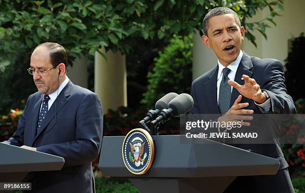 President Barack Obama answers a question as Iraqi Prime Minister Nuri al-Maliki looks on during a joint press conference following their meeting at...