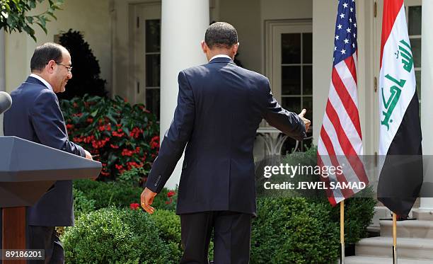 President Barack Obama shows Iraqi Prime Minister Nuri al-Maliki the way after giving a joint press conference following their meeting at the Rose...