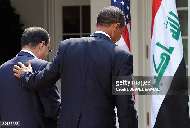 President Barack Obama shows Iraqi Prime Minister Nuri al-Maliki the way after giving a joint press conference following their meeting at the Rose...