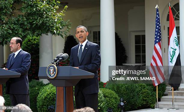 President Barack Obama answers a question as Iraqi Prime Minister Nuri al-Maliki during joint press conference following their meeting at the Rose...