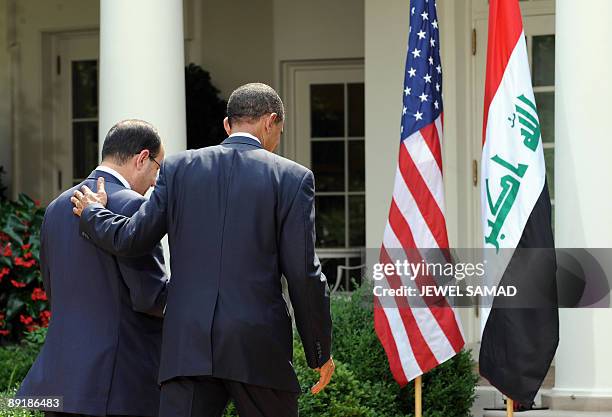 President Barack Obama shows Iraqi Prime Minister Nuri al-Maliki the way after giving a joint press conference following their meeting at the Rose...
