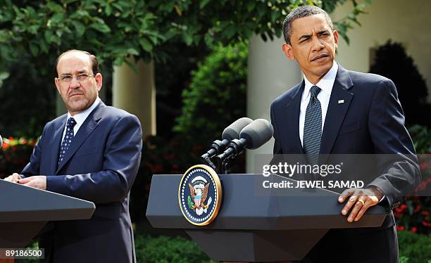 President Barack Obama and Iraqi Prime Minister Nuri al-Maliki listen a question during a joint press conference following their meeting at the Rose...