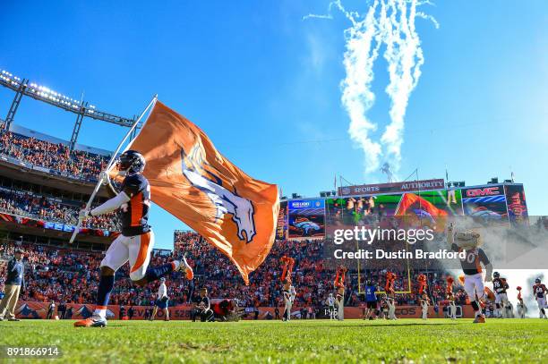 Defensive back Will Parks of the Denver Broncos carries a flag onto the field ahead of teammates before a game against the New York Jets at Sports...