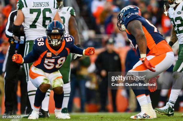 Outside linebacker Von Miller of the Denver Broncos celebrates along with nose tackle Zach Kerr after a sack against the New York Jets in the third...