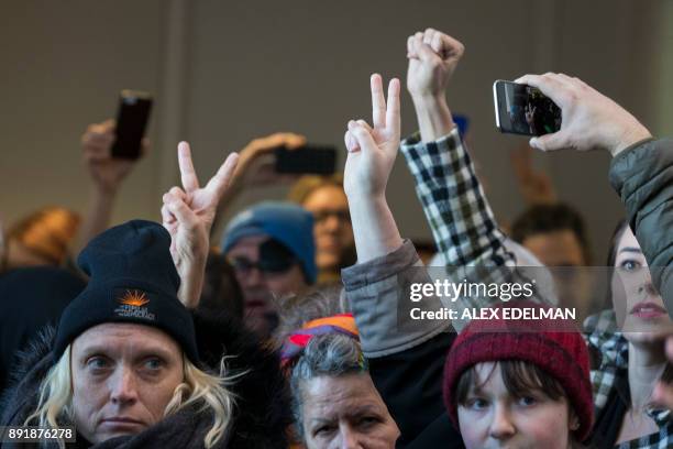 Demonstrators hold up two fingers signaling their second verbal warning from US Capitol Police officers who are ordering the protesters to disperse...