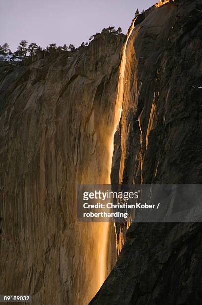 afternoon light on horsetail falls, a phenomenon that occurs once or twice a year in late february due to the angle of the sun and snow melt on the cliffs, yosemite valley, yosemite national park, unesco world heritage site, california, united states of am - light natural phenomenon stock pictures, royalty-free photos & images