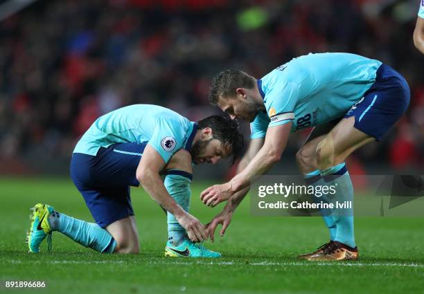 Simon Francis of AFC Bournemouth helps Harry Arter of AFC Bournemouth tie his boot lace during the Premier League match between Manchester United and...