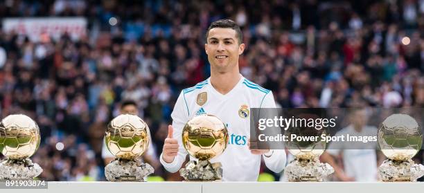 Cristiano Ronaldo of Real Madrid poses for photos with his FIFA Ballon Dor Trophies prior to the La Liga 2017-18 match between Real Madrid and...