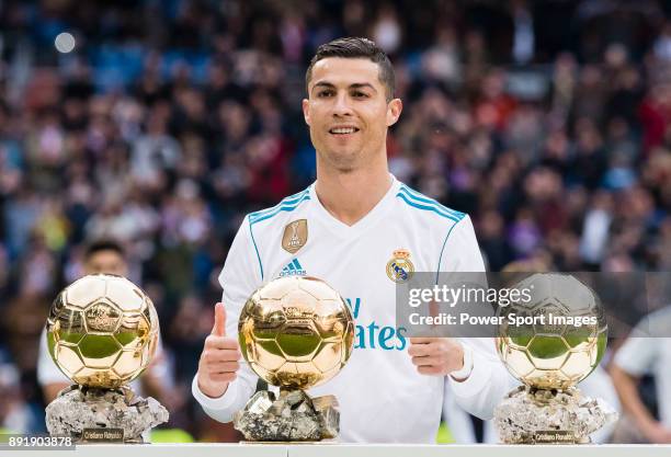 Cristiano Ronaldo of Real Madrid poses for photos with his FIFA Ballon Dor Trophies prior to the La Liga 2017-18 match between Real Madrid and...