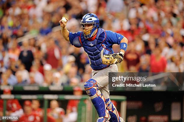 Koyie Hill of the Chicago Cubs looks to throw the ball during a baseball game against the Washington Nationals on July 18, 2009 at Nationals Park in...