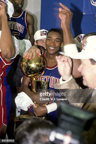 Finals: Detroit Pistons Isiah Thomas victorious with Larry O'Brien trophy after winning Game 4 and series vs Los Angeles Lakers. Inglewood, CA...