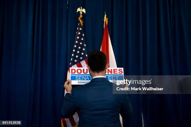 Adam Baron, a campaign worker for Senator-elect Doug Jones sets up fro a press conference on December 13, 2017 in Birmingham, Alabama. Jones stated...