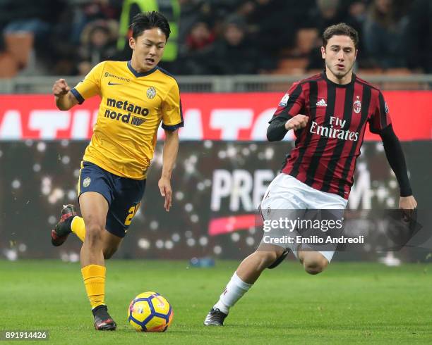 Lee Seung-Woo of Hellas Verona is challenged by Davide Calabria of AC Milan during the Tim Cup match between AC Milan and Hellas Verona FC at Stadio...