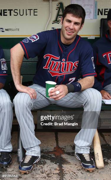 Joe Mauer of the Minnesota Twins gets ready in the dugout before the game against the Oakland Athletics at the Oakland-Alameda County Coliseum on...