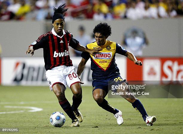 Ronaldinho of AC Milan moves the ball against Juan Carlos Silva of Club America during the World Football Challenge match at Georgia Dome on July 22,...