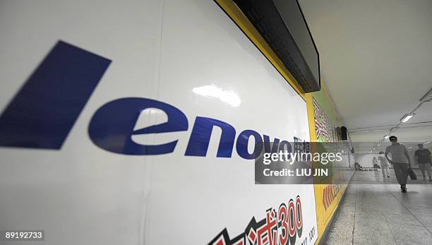 China-finance-economy-business-company-Fortune,ANALYSIS by D'Arcy Doran Pedestrians walk past an advertisement for China's computer maker Lenovo in...