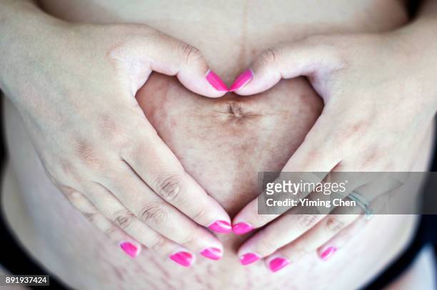 belly of a pregnancy woman - fetus heart stock pictures, royalty-free photos & images