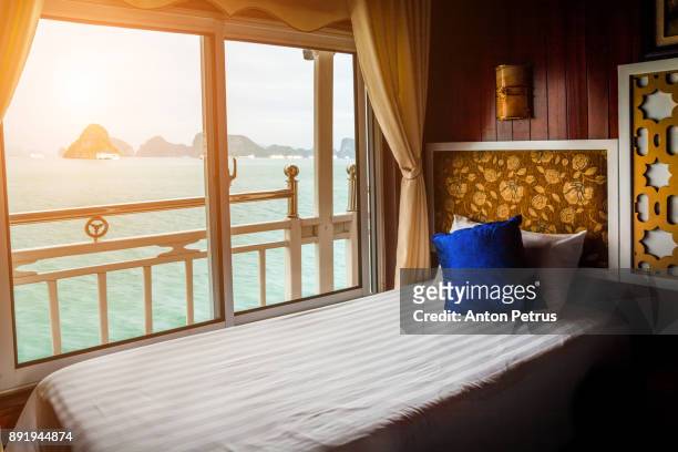 bed in cruise ship cabin. halong bay, vietnam - cruise ship cabin photos stock pictures, royalty-free photos & images