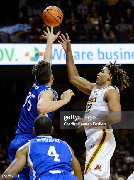 Reggie Lynch of the Minnesota Golden Gophers shoots the ball against Nick McGlynn of the Drake Bulldogs during the game on December 11, 2017 at...