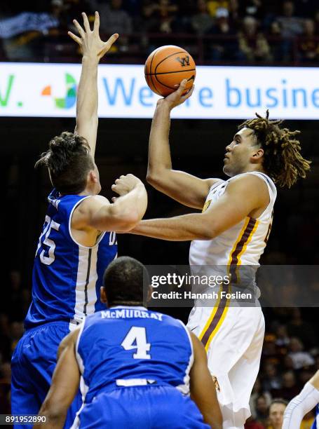 Reggie Lynch of the Minnesota Golden Gophers shoots the ball against Nick McGlynn of the Drake Bulldogs during the game on December 11, 2017 at...