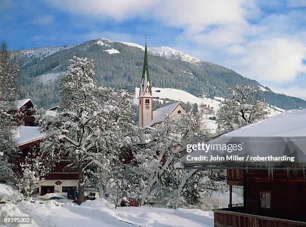 snow covers the village and church of alpbach in the tyrol in the winter, austria, europe - alpbach ストックフォトと画像