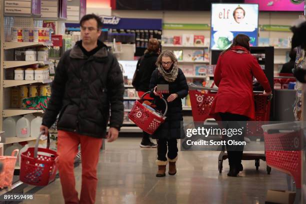 Customers shop at a Target store on December 13, 2017 in Chicago, Illinois. Target announced today it will acquire Shipt, a same-day delivery...