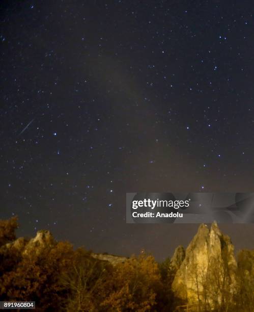Meteors named as 'Geminid' streak across the sky over Abaci fairy chimneys located at Kizilcahamam district of Turkey's Ankara on December 14, 2017.