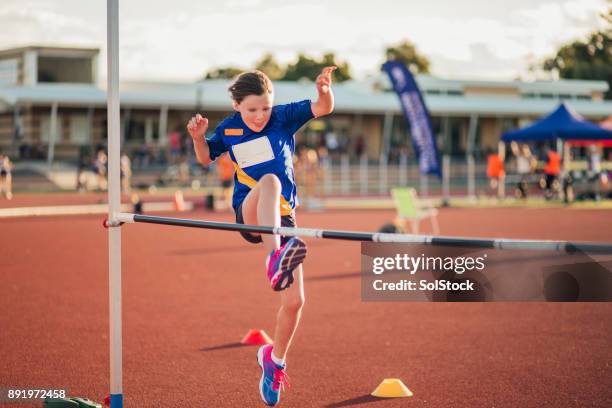 doing the high jump at athletics club - womens high jump stock pictures, royalty-free photos & images