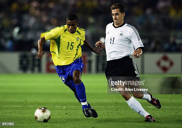 Kleberson of Brazil is watched by Miroslav Klose of Germany during the Germany v Brazil, World Cup Final match played at the International Stadium...