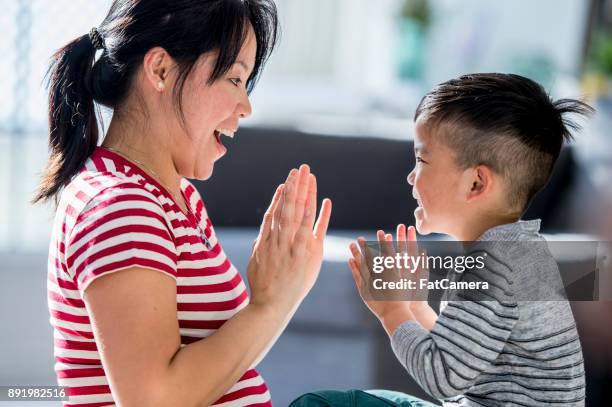 playing patty cake - clapping game stock pictures, royalty-free photos & images