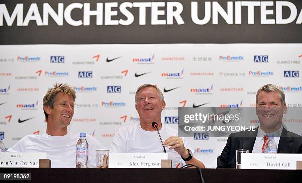 Manchester United's chief executive David Gill, manager Alex Ferguson and goalkeeper Edwin Van der Sar smile during a press conference at a hotel in...