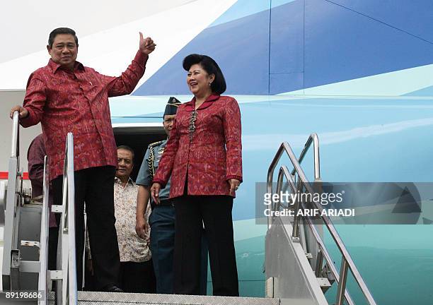 Indonesian President Susilo Bambang Yudhoyono gestures next to first lady Ani Yudhoyono during the inauguration of new Airbus A330-200 and Boeing...
