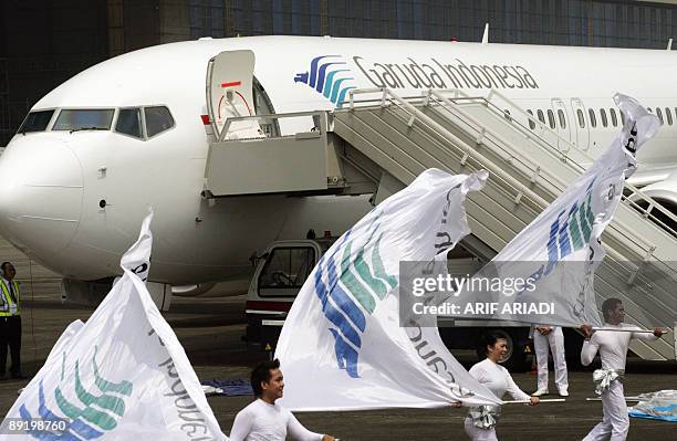 Indonesian dancers perform with an Airbus A330-200 in the background during the launching of new Airbus A330-200 and Boeing 737-800 NG planes at the...