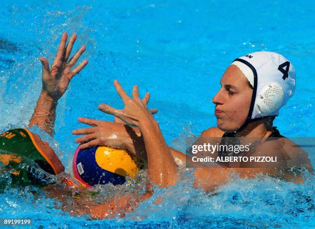 Canadian Emily Csikos fights for the ball with South African Nicolette Poulos during the water-polo game Canada vs. South Africa on July 23, 2009 at...