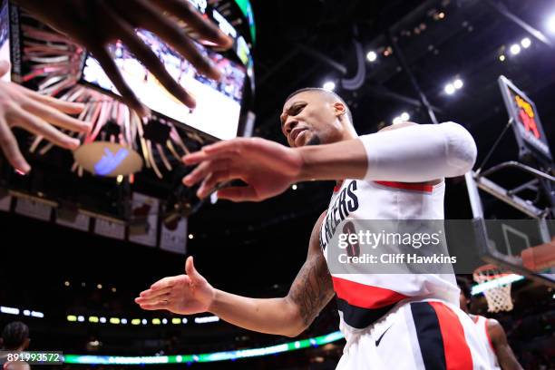 Damian Lillard of the Portland Trail Blazers celebrates a basket with teammates in the fourth quarter against the Miami Heat at American Airlines...