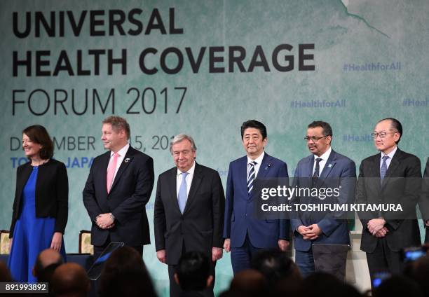 Japanese Prime Minister Shinzo Abe and United Nations Secretary-General Antonio Guterres pose with Interim Executive Director of the Global Fund To...