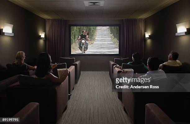 watching movie in home theater - home movie stock pictures, royalty-free photos & images