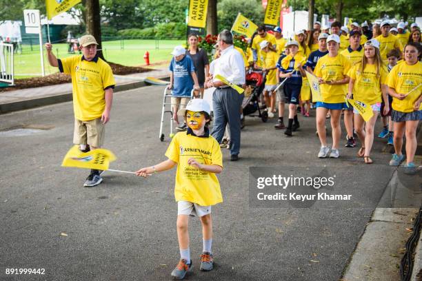 Participants walk in Arnie's Army Charitable Foundation's Arnie's March held following practice for the TOUR Championship, the final event of the...