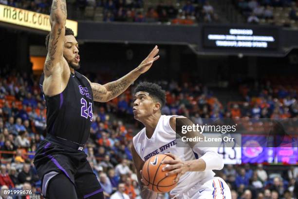 Guard Chandler Hutchison of the Boise State Broncos drives to the hoop through the defense of forward Keonta Vernon of the Grand Canyon Lopes during...