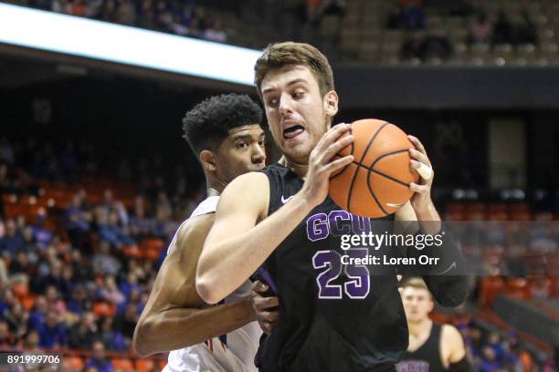 Forward Alessandro Lever of the Grand Canyon Lopes backs into the paint through the defense of guard Chandler Hutchison of the Boise State Broncos...