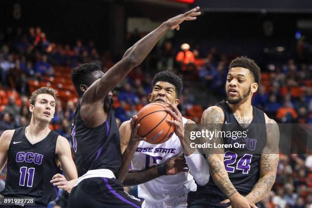 Guard Fiifi Aidoo and forward Keonta Vernon of the Grand Canyon Lopes box in guard Chandler Hutchison of the Boise State Broncos during first half...