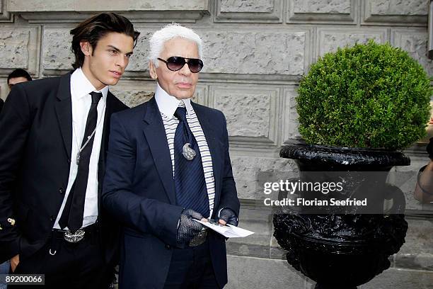 Designer Karl Lagerfeld and model Baptiste Giaconi leave the Hotel de Rome on July 23, 2009 in Berlin, Germany.