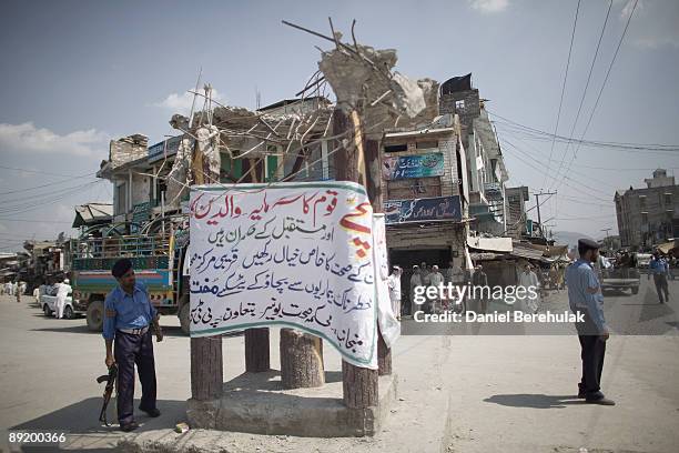 Pakistan Police stand guard at a main crossing point in the city of Dagar on July 16, 2009 in the Buner district, Pakistan. Thousands of IDPs have...